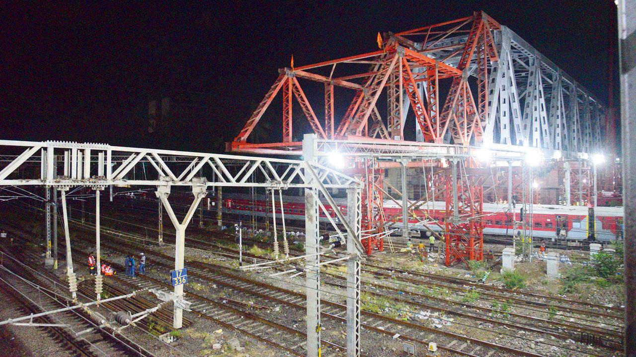 Workers launched the girder above railway lives at Vidyavihar station, post midnight, on the intervening night of Saturday and Sunday. Pic/Pradeep Dhivar