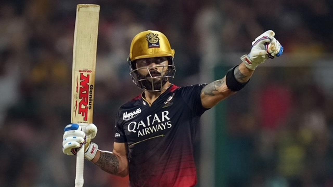 Royal Challengers Bangalore`s Virat Kohli celebrates his century against Gujarat Titans in Bangalore on May 21. Pic/PTI