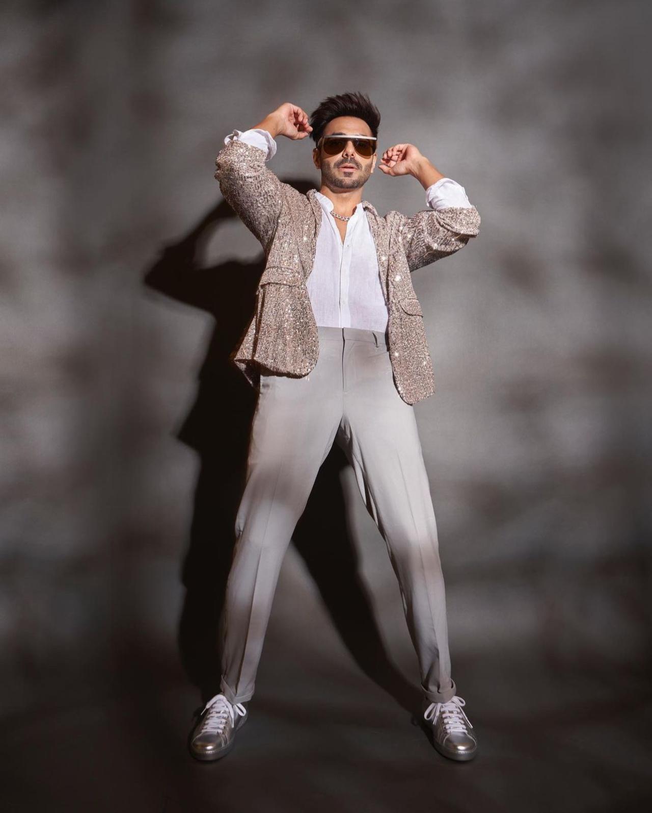 Aparshakti Khurana is not only known for his acting prowess but also for his edgy and stylish fashion choices. Recently, at an award show, he made heads turn with a white shirt, grey pants, and an offbeat sparkly blazer. Paired with uber-cool shades, Aparshakti's fashion sense exudes confidence and a willingness to stand out from the crowd.