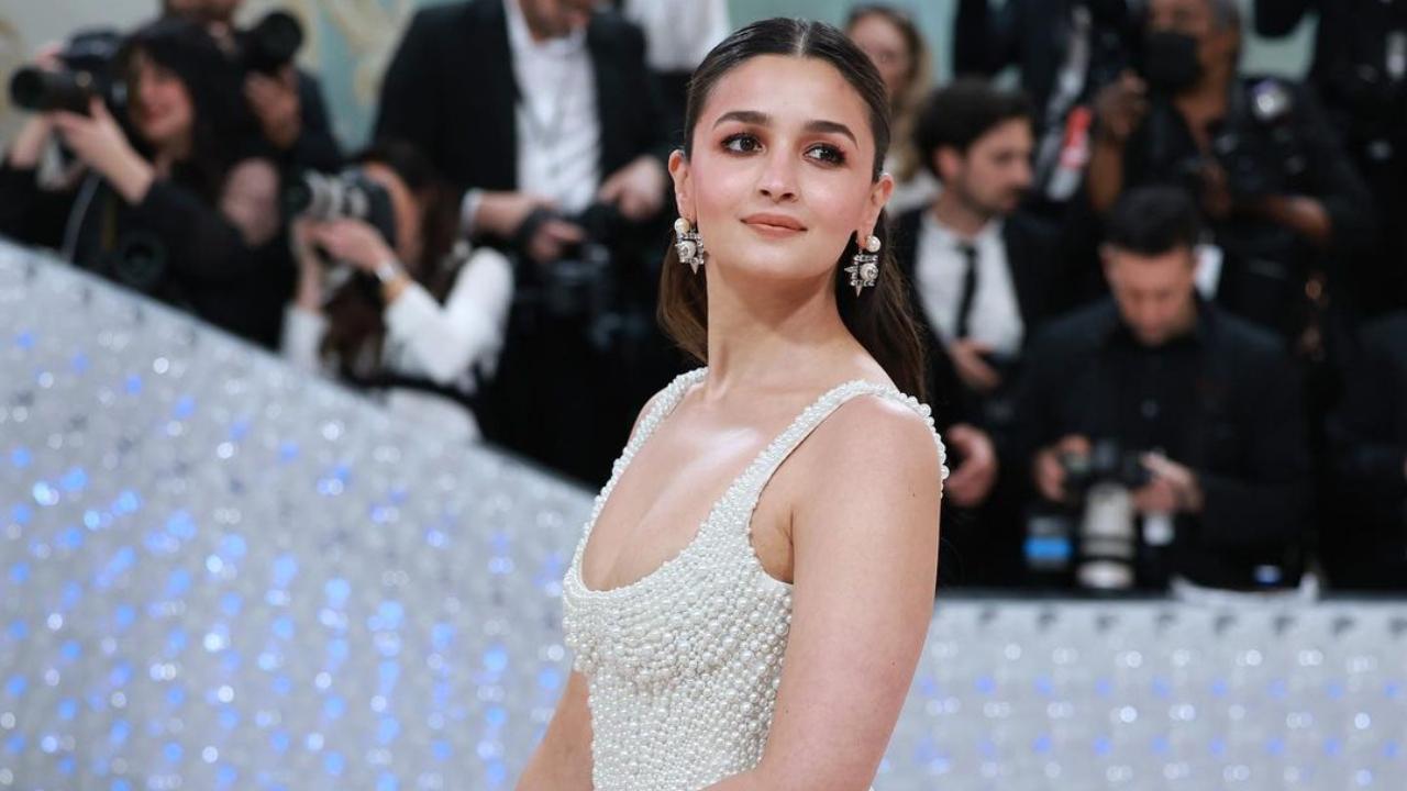 Alia Bhatt made an entrance in a gown that seemed to take inspiration from the attire of a princess bride, designed in white and embellished with pearls. Her hair was styled in a ponytail.
 