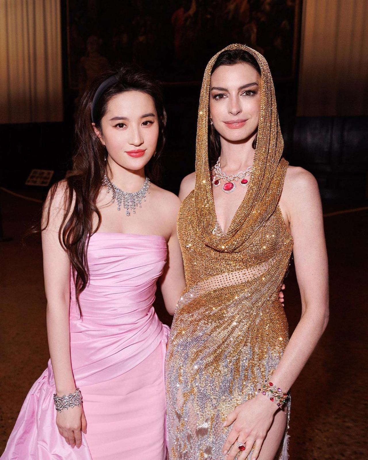 American actress Anne Hathaway poses with Chinese actor and singer Liu Yifei, who played the title role in the popular film Mulan