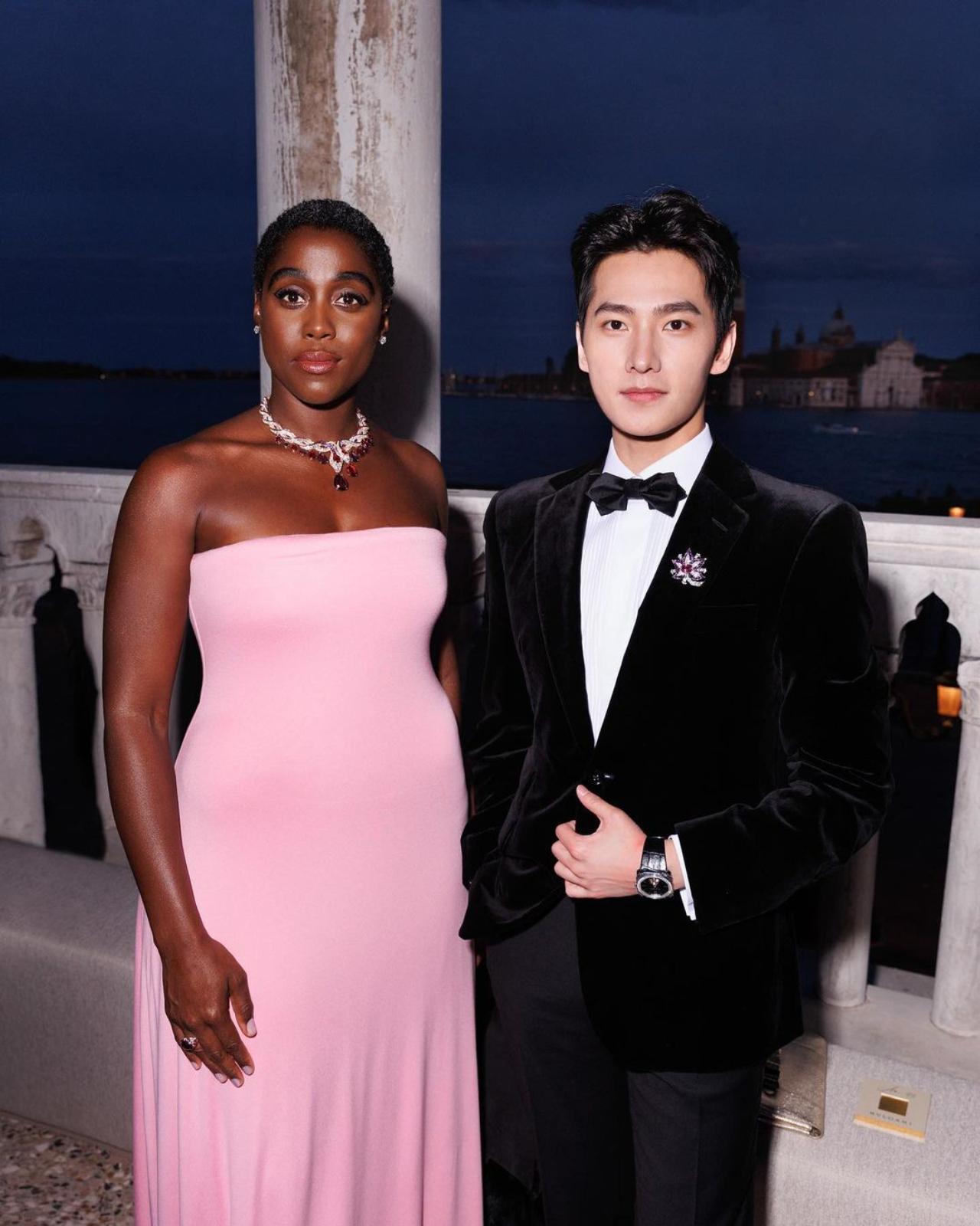Lashana Lynch is a British actress. She is best known for playing the role of Maria Rambeau in the Marvel Cinematic Universe (MCU) films Captain Marvel and Doctor Strange in the Multiverse of Madness, MI6 agent Nomi in the James Bond film No Time to Die, and as Izogie in The Woman King. Yang, a Chinese actor photographed alongside Lynch is the face of Bulgari Perfumes