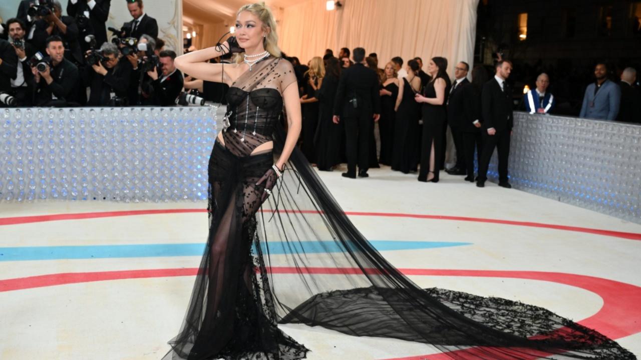 Gigi Hadid too went with a black outfit wearing a custom Givenchy sheer black gown and paired it up with statement jewellery. Photo Courtesy: AFP