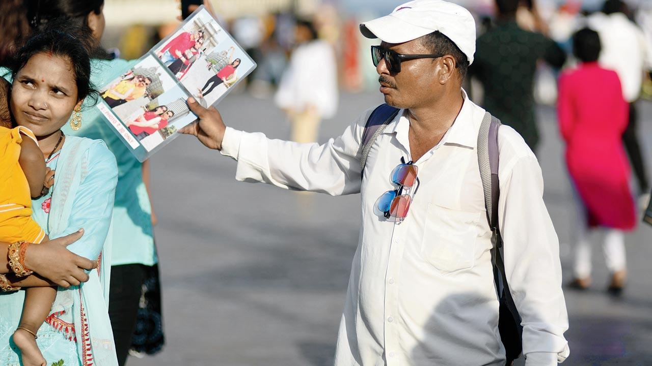 Gateway of India photographer Akhilesh Pandey doesn’t step out without his sunglasses and cap. Pic/Sameer Markande