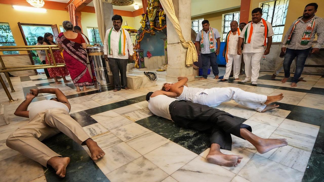 Congress workers perform 'Urulu Seve' at Bhagawan Sree Maruthi Temple to celebrate the party's win in Karnataka Assembly elections, in Bengaluru, Sunday, May 14, 2023. Attributing the victory to Bharat Jodo Yatra, Congress President Mallikarjun Kharge said that the party has won almost 99 per cent of the seats in the route in which Rahul Gandhi walked for Bharat Jodo Yatra. PTI Photo
