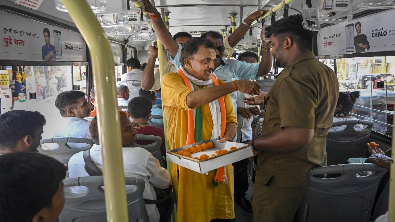 Senior Congress leader Sanjay Nirupam offers sweets to party leaders and workers celebrating the party's win in Karnataka Assembly elections, in Mumbai, Sunday, May 14, 2023. The victory has come at a time when the Congress is seeking momentum ahead of next year's general elections. A string of state polls are also due later this year, including in Madhya Pradesh, Chhattisgarh, Rajasthan and Telangana. PTI Photo