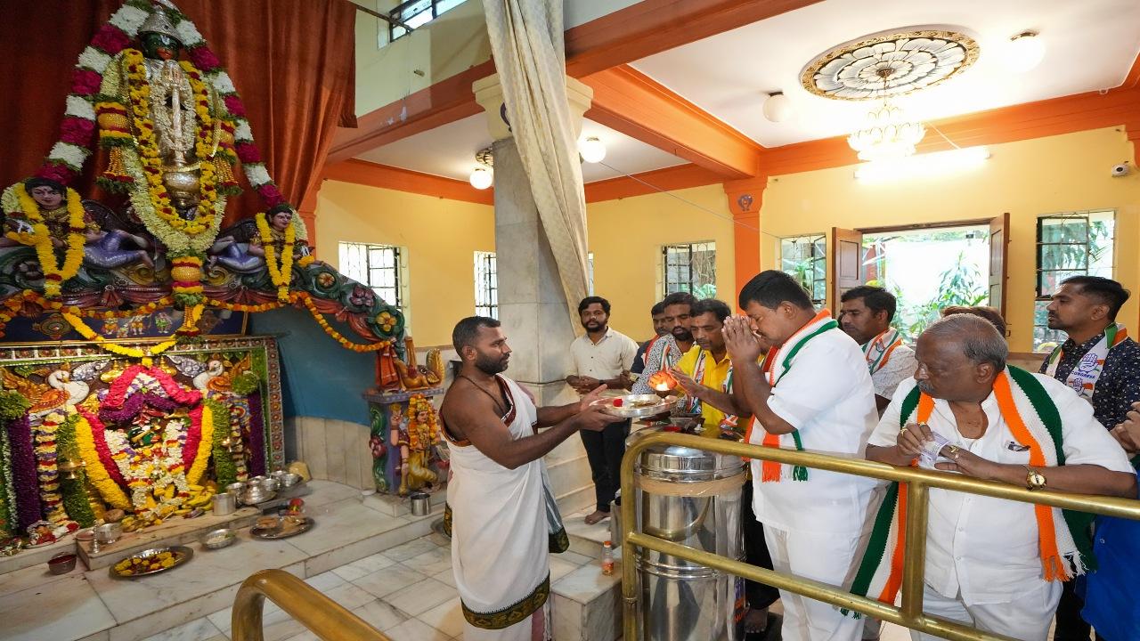 Congress workers offer prayers at Bhagawan Sree Maruthi Temple following the party's win in Karnataka Assembly elections, in Bengaluru, Sunday, May 14, 2023. 