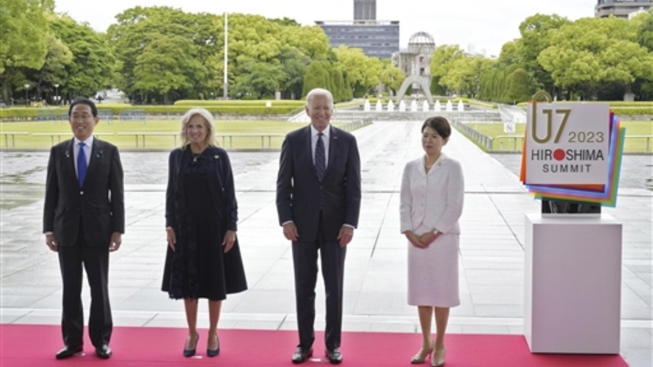 U.S. President Joe Biden, center right, and first lady Jill Biden, center left, are welcomed by Japan's Prime Minister Fumio Kishida and his wife Yuko Kishida at the Peace Memorial Park