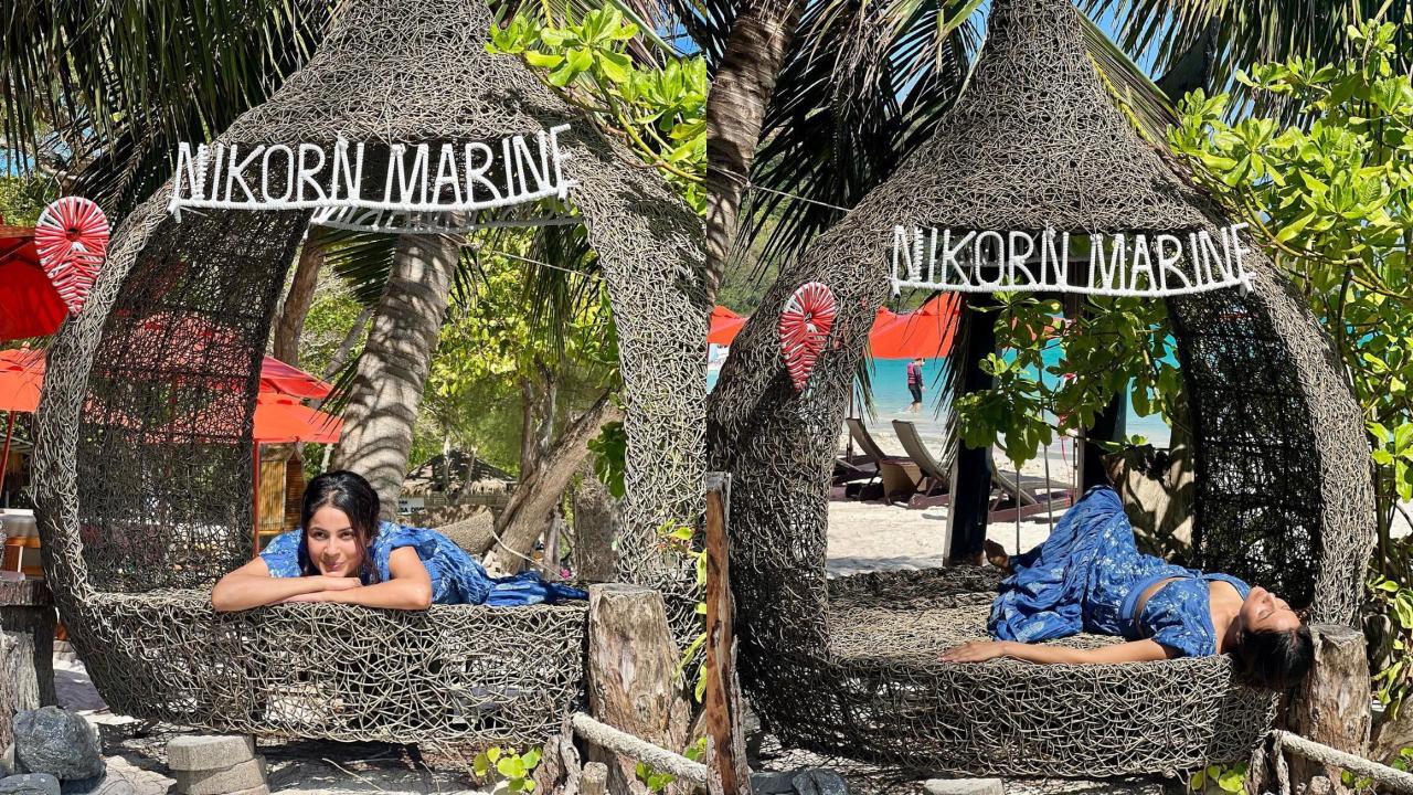 In a lovely blue co-ord outfit, Shehnaaz Gill is observed basking in the sun on the beach and at her lodging. She is captured posing within a substantial fabricated nest bearing the name 'Nikorn Marine.'