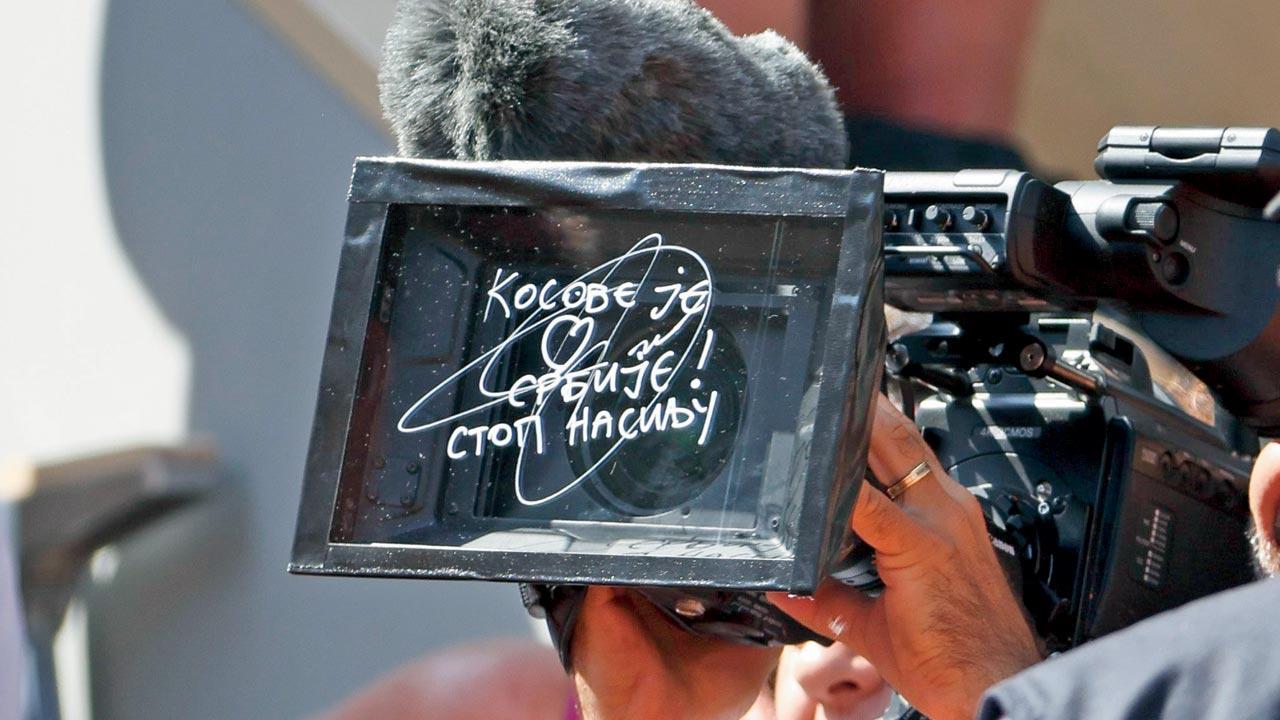 Djokovic writes ‘Kosovo is the heart of Serbia. Stop the violence’ on a camera lens after his win, highlighting the ongoing tension between Kosovo and Serbia. Pics/Getty Images