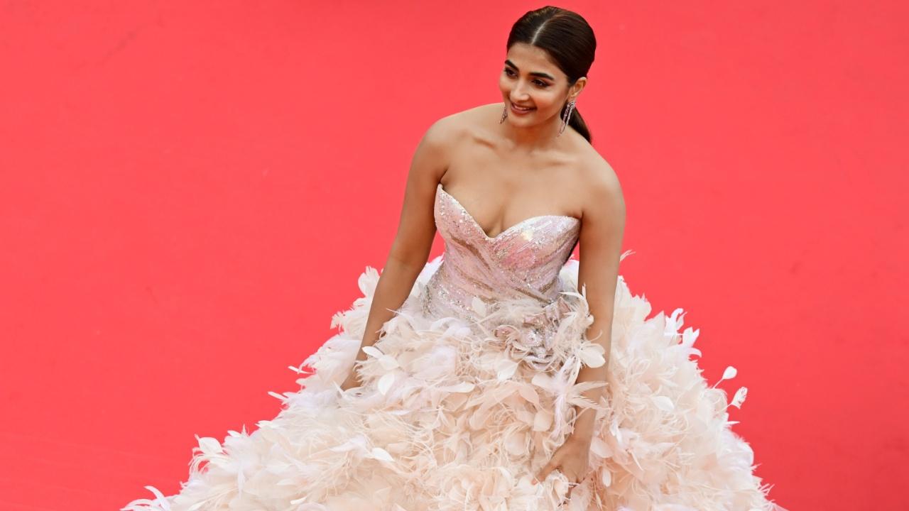 Actor Pooja Hegde looked all chic in her feathery pink gown marking her debut at the French Riviera. Her gown was by a Lebanese fashion designer, Geyanna Youness's eponymous brand ‘Maison Geyanna Youness'. Photo Courtesy: AFP