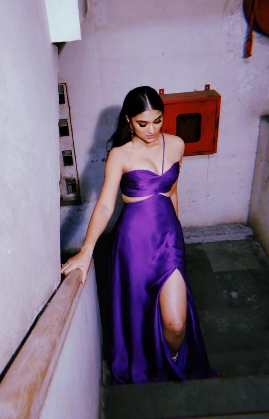 Saiee M Manjrekar, the rising star on the horizon, made a bold statement in an edgy purple cutout gown. With a touch of shine on the gown and a high slit, she showcased her innate fashion sense. The smokey eye glam, soft lips, and perfectly tucked hair behind the ear further added to her overall glamorous appeal.