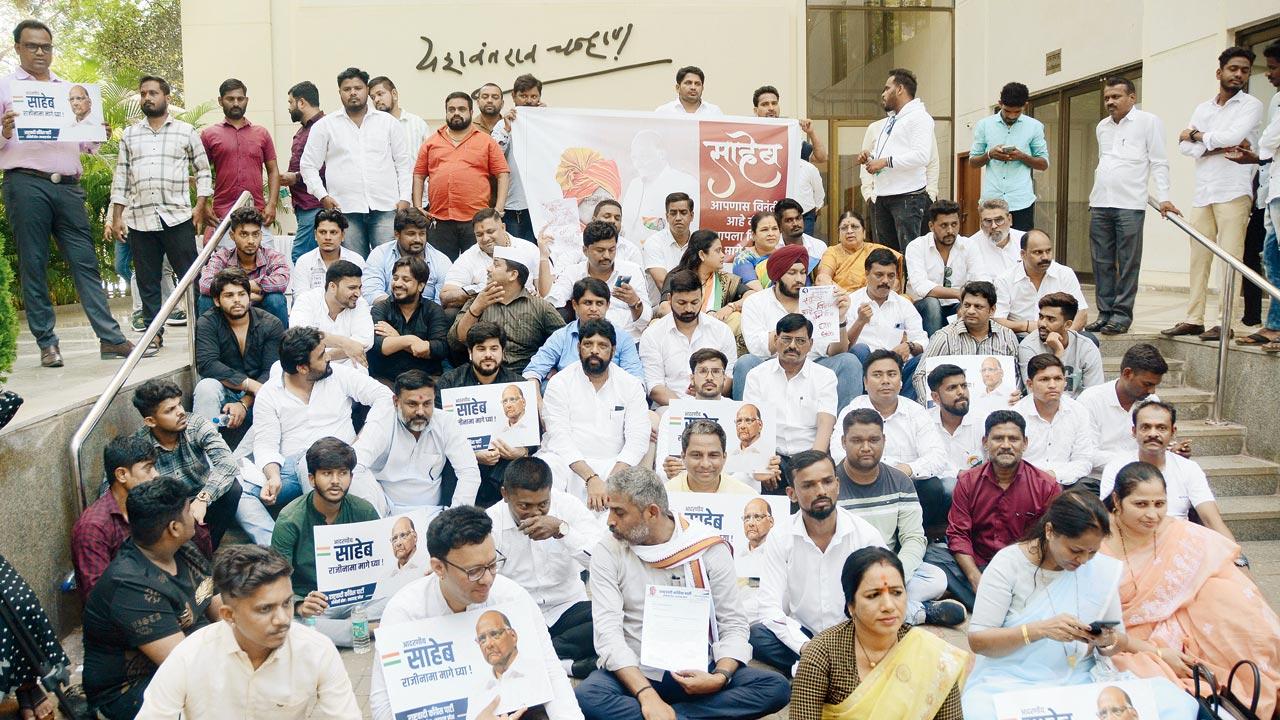 NCP workers and supporters sit outside the centre hoping the senior leader will revoke his decision to step down as president of the party