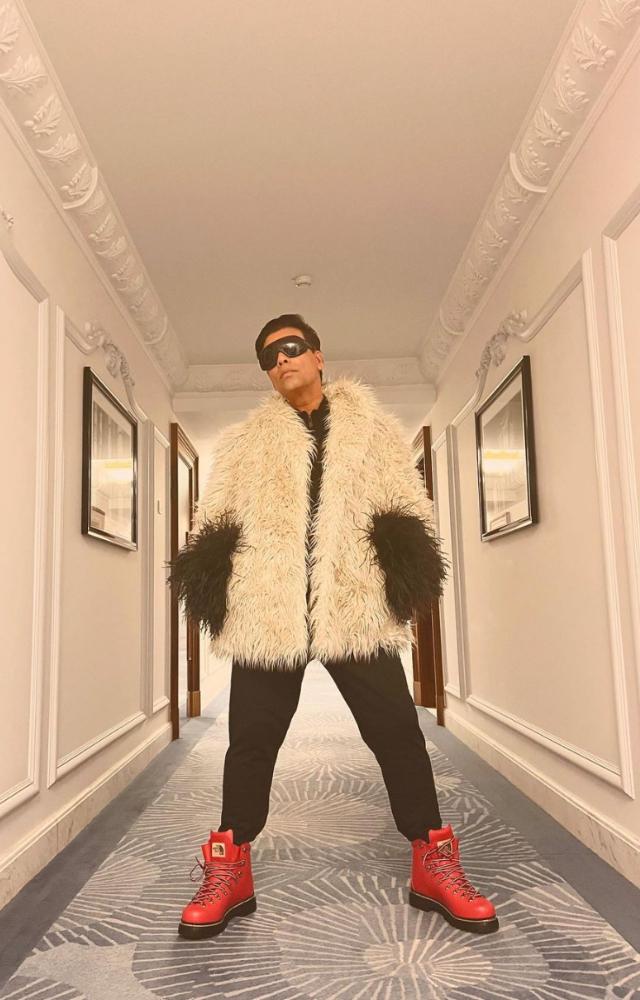 Karan donned a pair of black trousers with a sweatshirt, teaming up with a pair of crimson boots. He accessorised the outfit with a pair of black sunglasses.