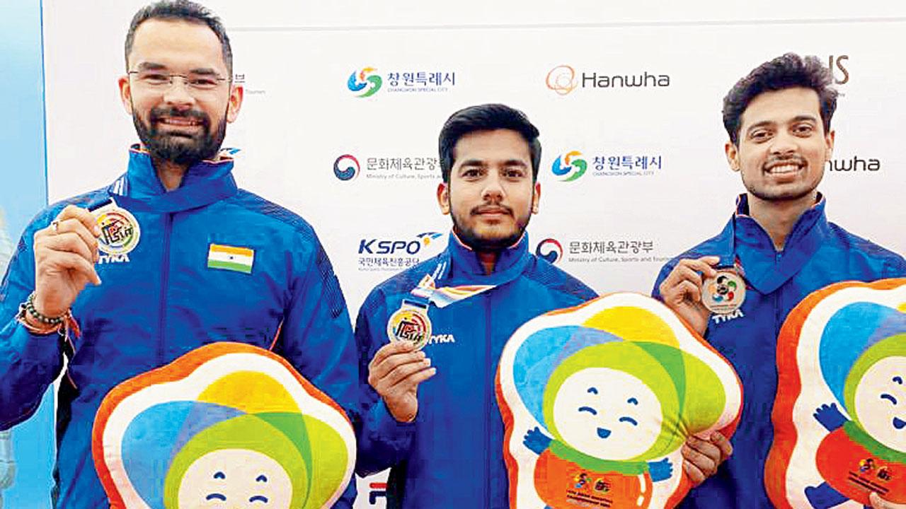 The silver-winning trio of Akhil Sheoran (left), Aishwary Tomar and Swapnil Kusale (right) in Changwon, Korea, yesterday. Pic/NRAI
