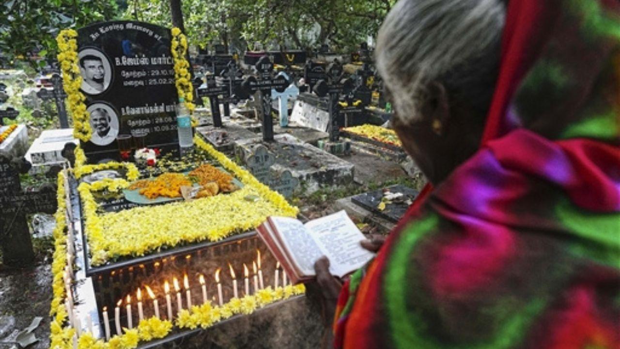 The cemetery was adorned with candles, flower petals, and garlands on the graves, emphasizing the importance of remembrance and respect.