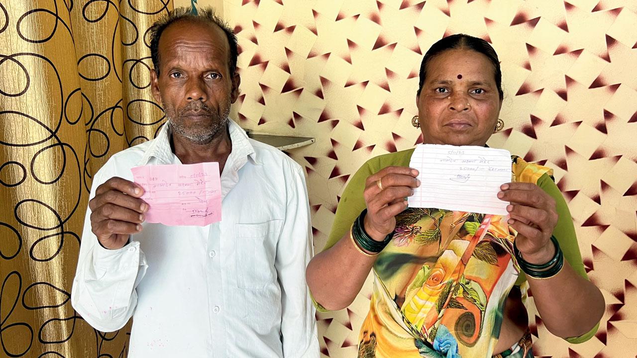 Kamla and Namdev Meher holding receipts of the fine paid