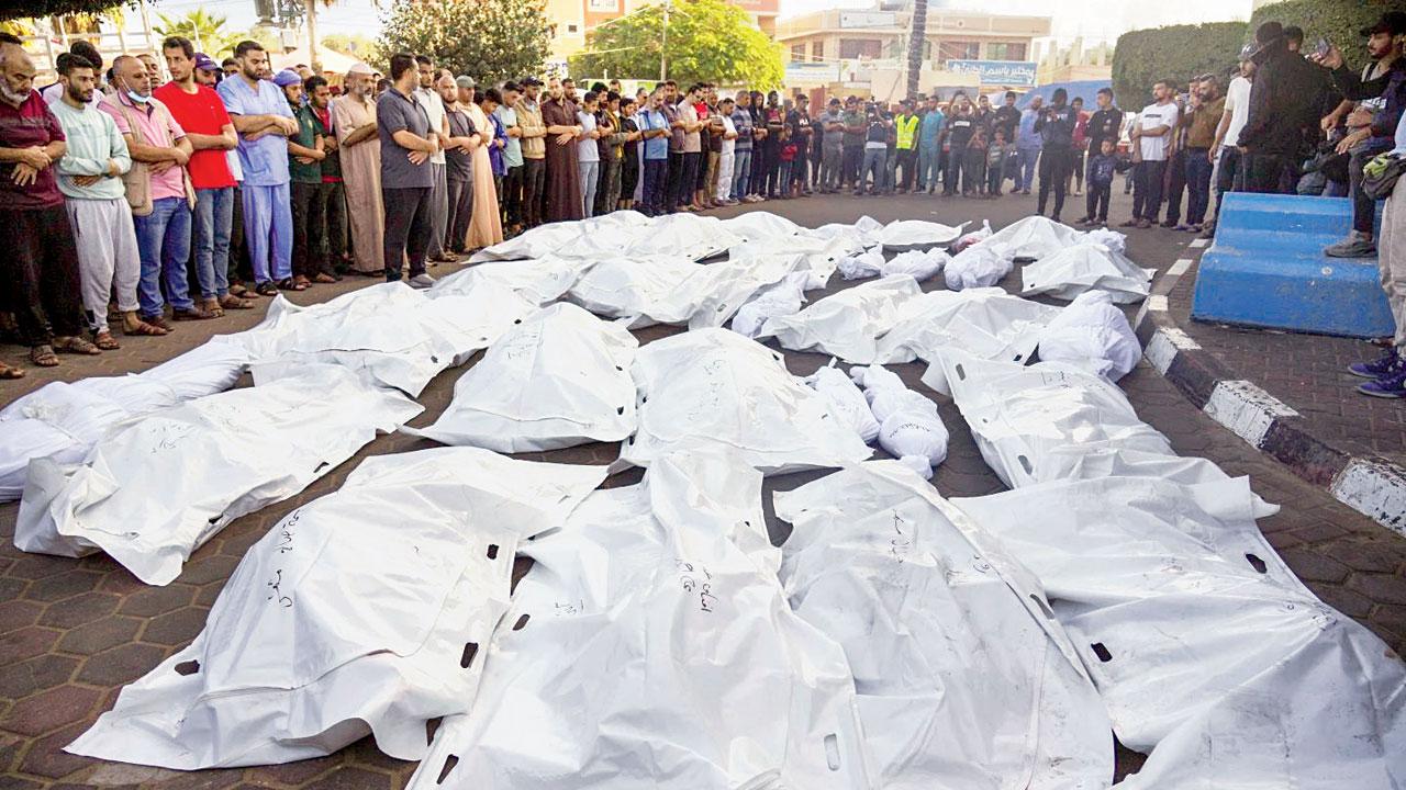 Palestinians mourn the deaths of relatives killed in Israeli bombardment. Pic/AP