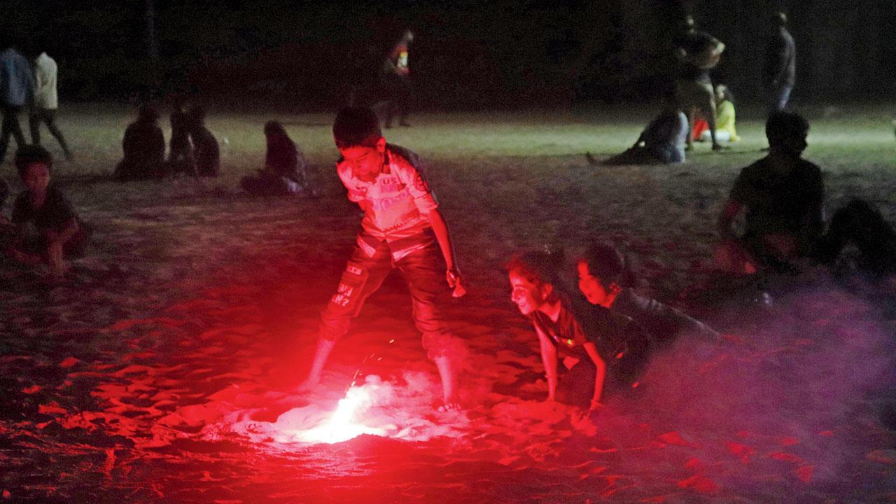 People celebrating Diwali with firecrackers at Juhu beach on Sunday. Pic/Anurag Ahire