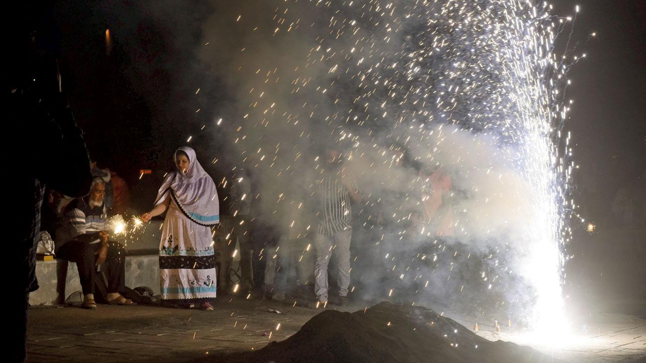 Firecrackers are burst by families at Marine Drive. Pic/Shadab Khan