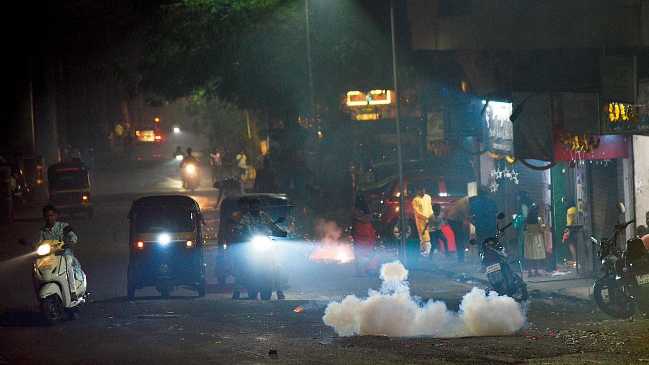 People burst firecrackers on Nehru Road at Saraswat Colony, Dombivli East on Sunday. Pic/Satej Shinde