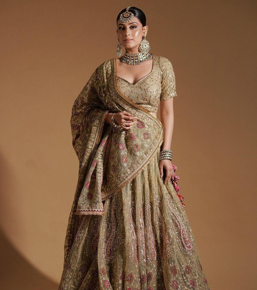 Looking for a heavy outfit to nail your look at your brother's wedding reception? How about wearing Isha's stunning beige lehenga?