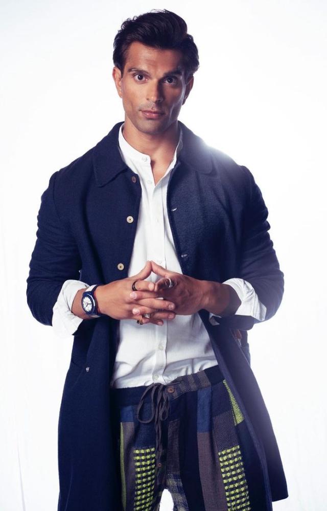 Karan Singh Grover looked incredibly hot in a white shirt, paired with a funky track and a blue long jacket