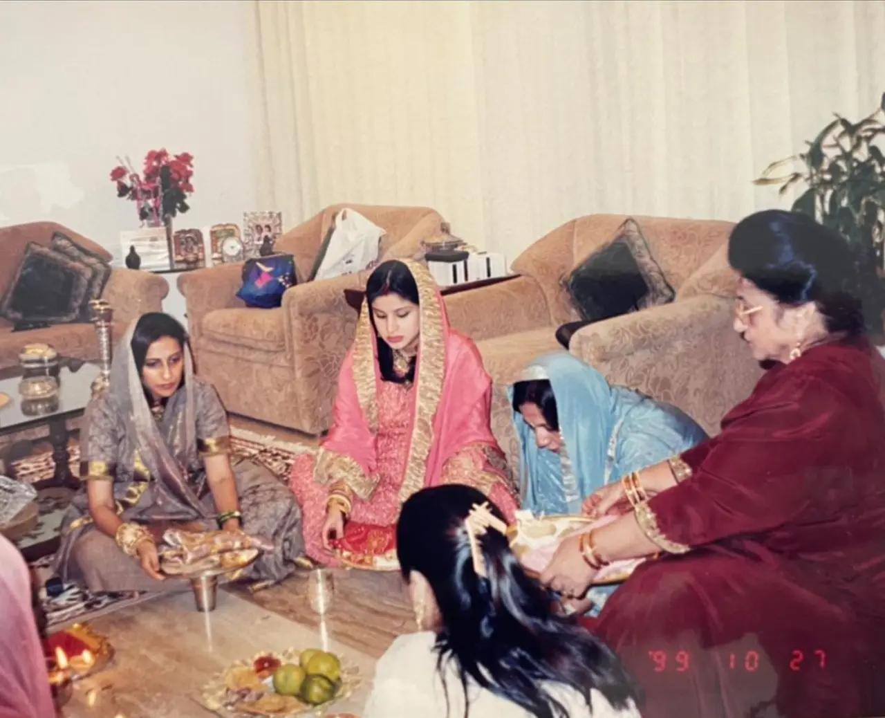 In this picture, a pregnant Maheep can be seen following rituals along with sister-in-law, Sunita Kapoor, mother-in-law, and Varun Dhawan's mother Laali Dhawan