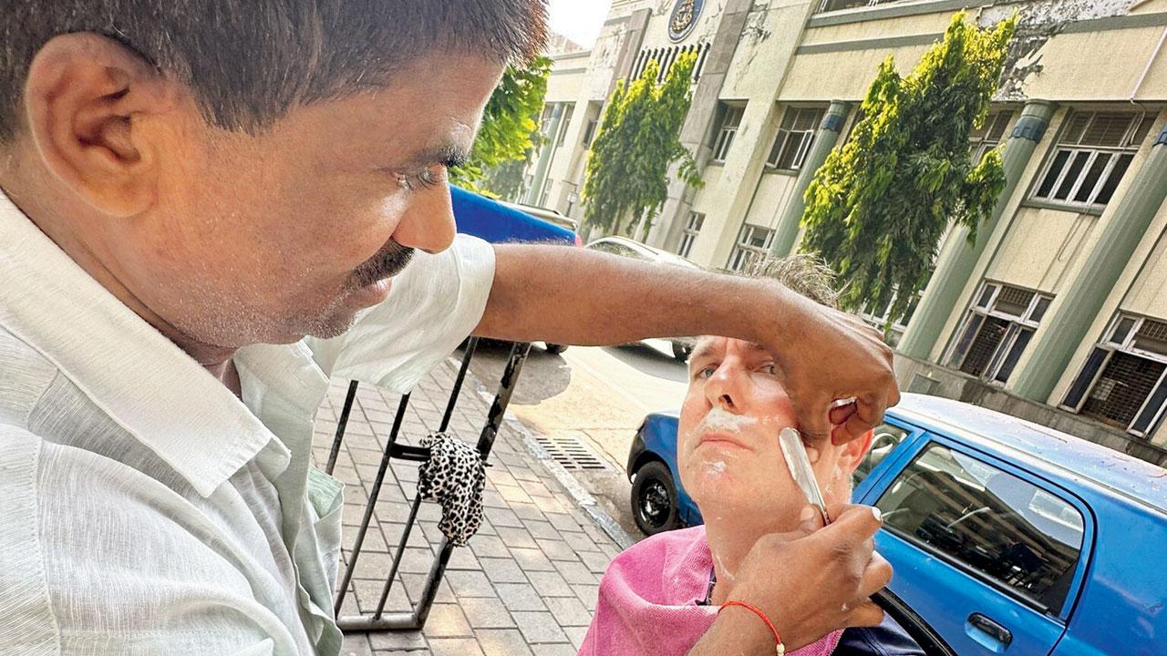 Vaughan gets a shave at Dindayal’s roadside barbershop on Orminston road in Colaba