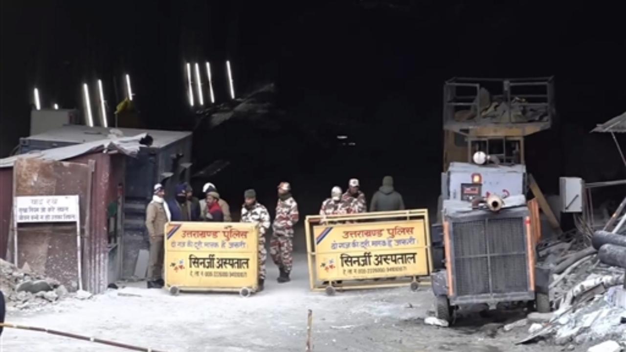 Security forces personnel guard as rescue work continues after a portion of an under construction tunnel collapsed