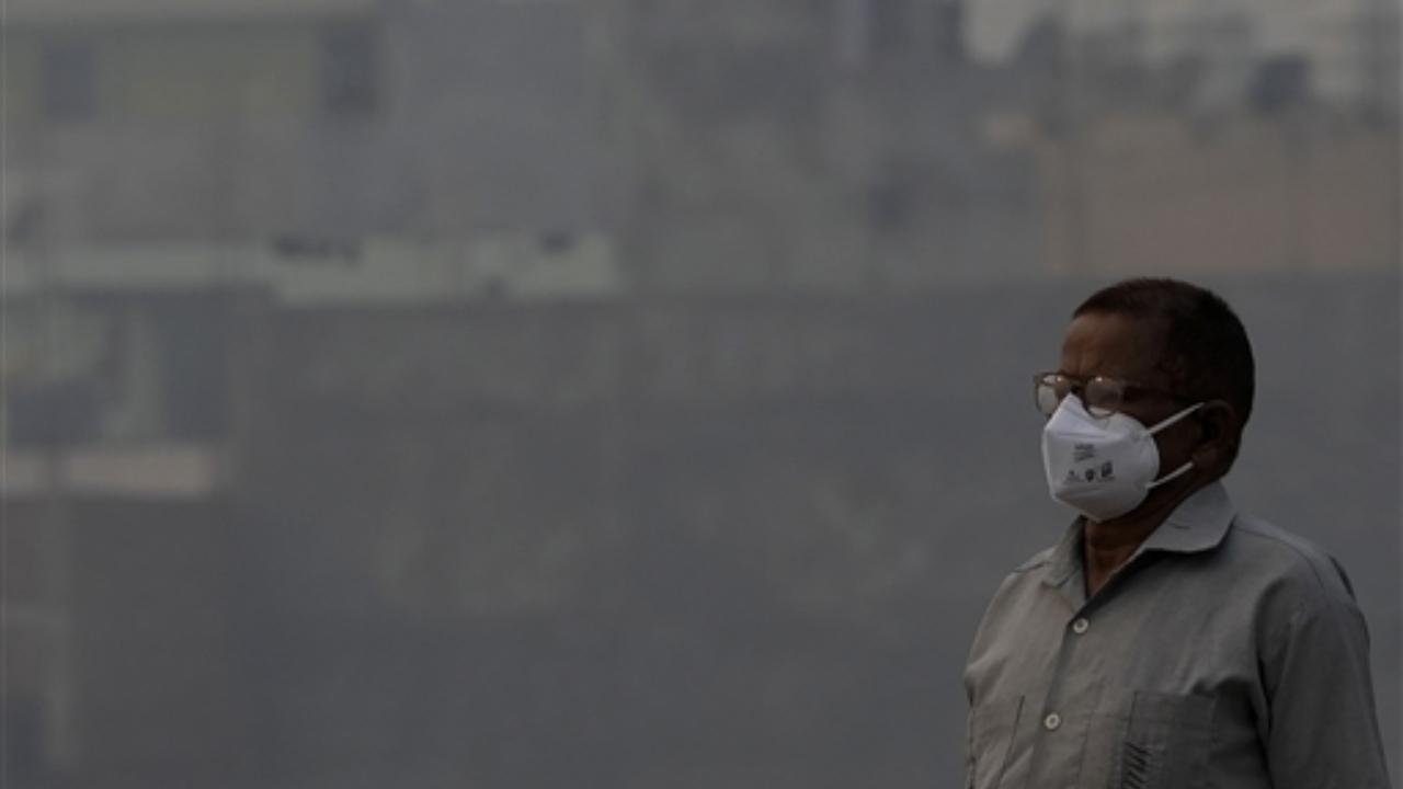 A man wears anti-pollution mask to protect himself from growing level of air pollution, in New Delhi, Thursday, Nov. 2, 2023