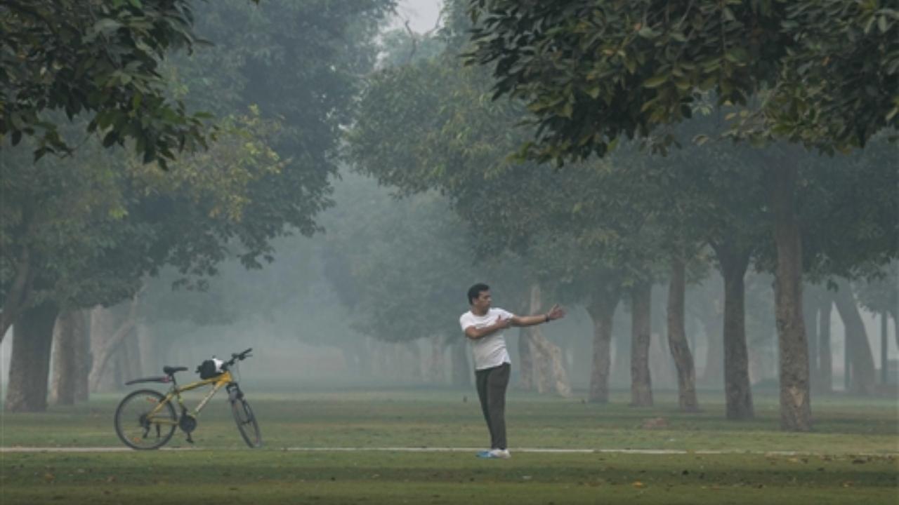 A man exercises at a park during a smoggy morning, in New Delhi, Thursday, Nov. 9, 2023. The air quality in Delhi was recorded in the 'severe' category on Thursday morning