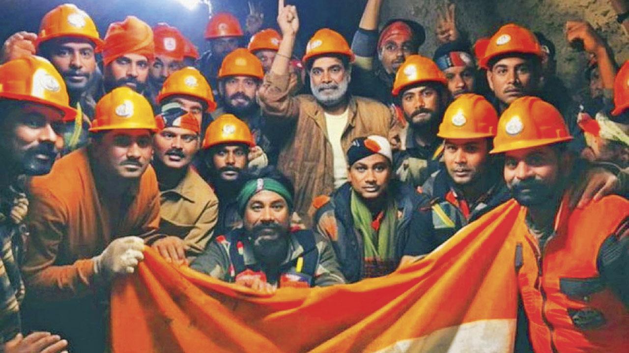 Rescue officials pose for group photos after the successful evacuation of 41 workers. Pics/PTI