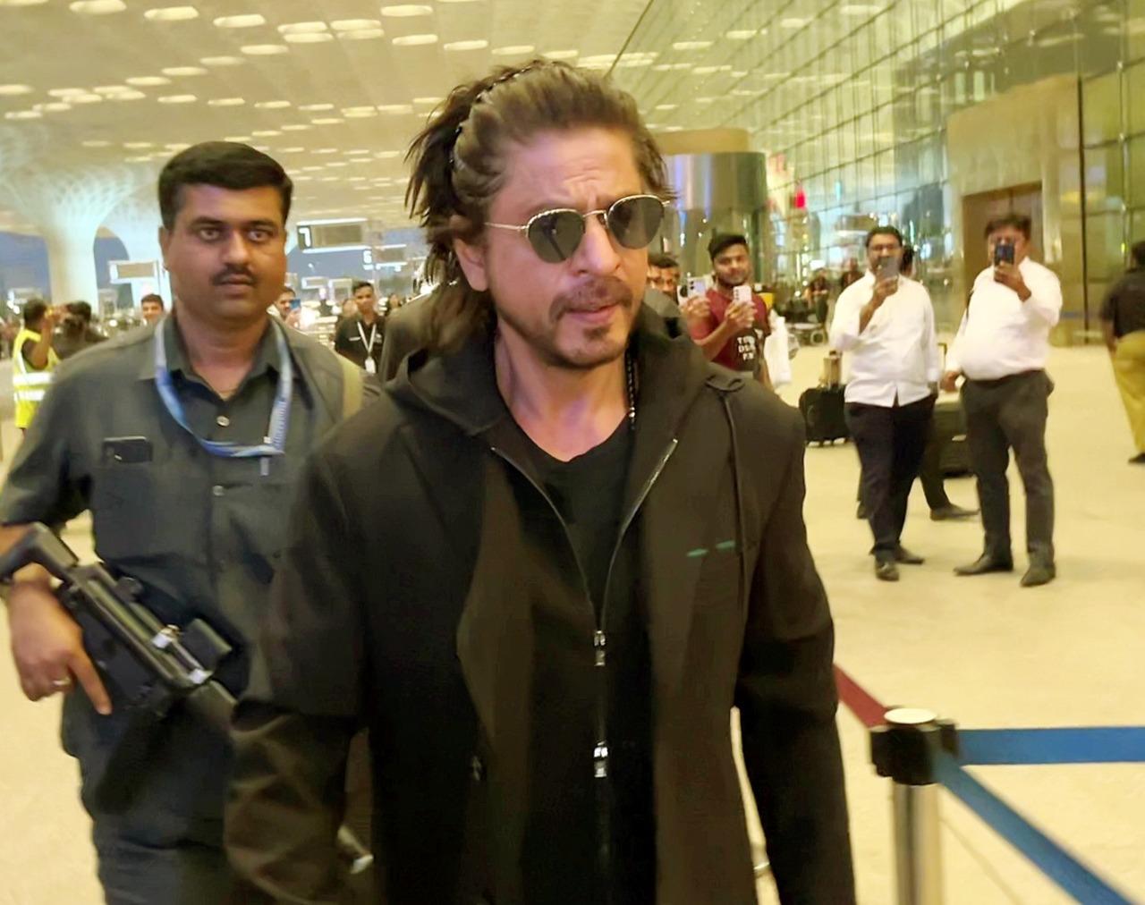 SRK looked stunning in an all-black suit at the airport sporting long hair