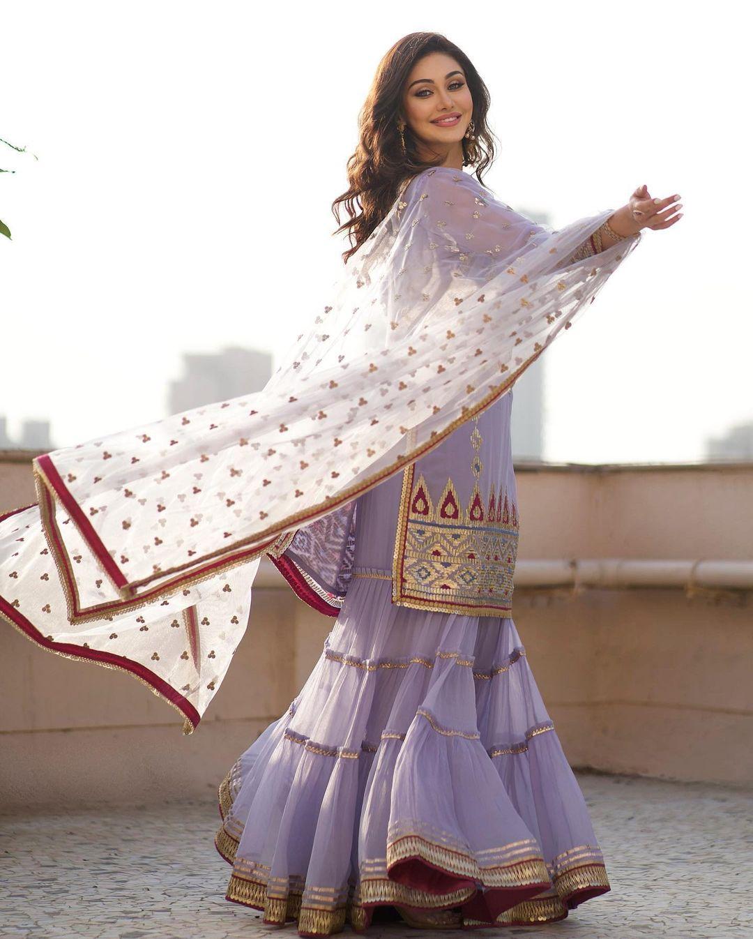 If you don't want to go for lehengas or sarees then we got you covered. Shefali's purple colour sharara suit set is what can help you slay the festive look