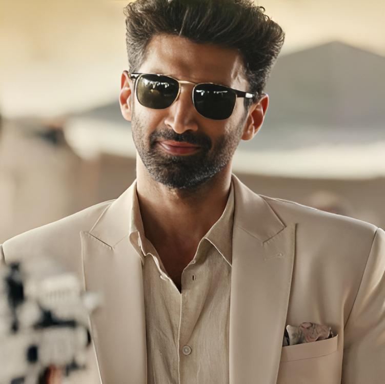 The glasses, the suit, the smirk, all of it is just *chef's kiss*. No one does it quite like Aditya Roy Kapur