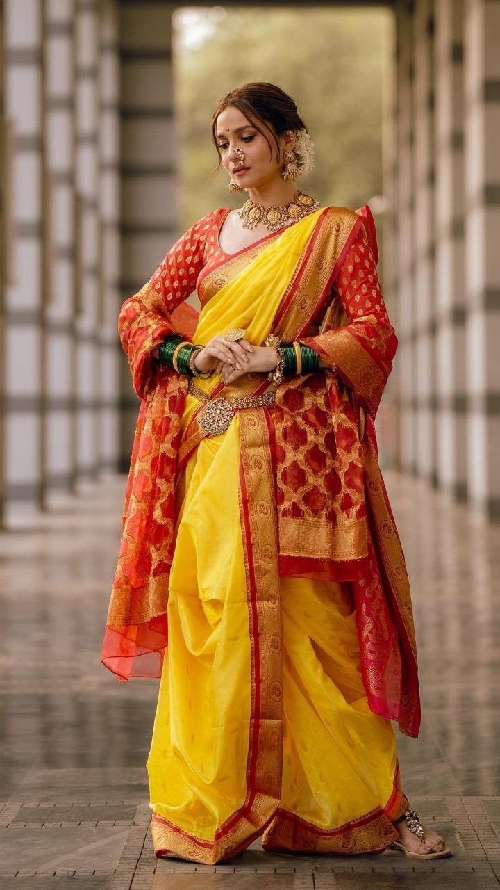 Ankita wore a yellow and orange paithani for one of her wedding ceremonies with Vicky Jain. The actress looked gorgeous
