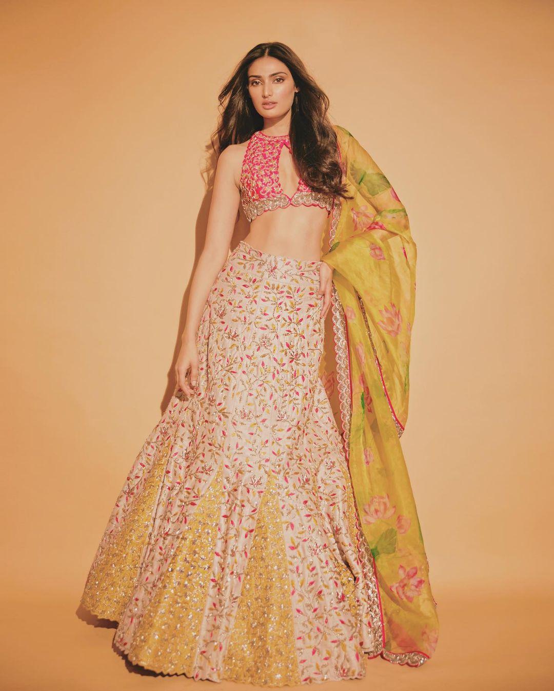 It's time to up your game this Diwali 2023! Athiya Shetty's ethnic wardrobe gives us the perfect inspiration for the festive season. For instance, this coral lehenga set is the perfect mix of contemporary and traditional. The top is a chic halter neck with a floral printed skirt