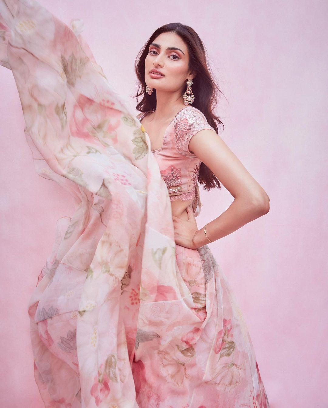 Athiya appeared stunning in a lovely floral lehenga. She's showcasing her fondness for traditional clothing in a beautiful pink floral-printed lehenga designed by Shehla Khan.