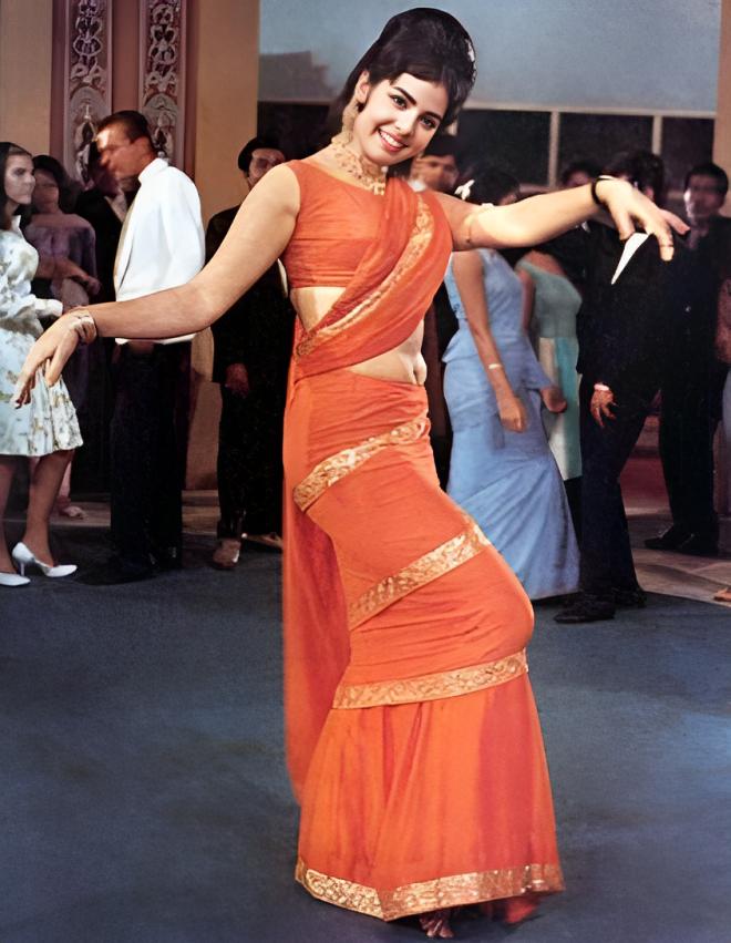 Mumtaz's 'Aaj Kal Tere Mere Pyaar Ke Charche' iconic look sealed her fate as a bonafied fashion queen. She put the risque sarees on the map for years and years to come. Mumtaz's low-waist, pre-pleated saree with gold gota bordes and the iconic frilly hemline made this look stand out for what it was for that time: bold, beautiful, and legendary.