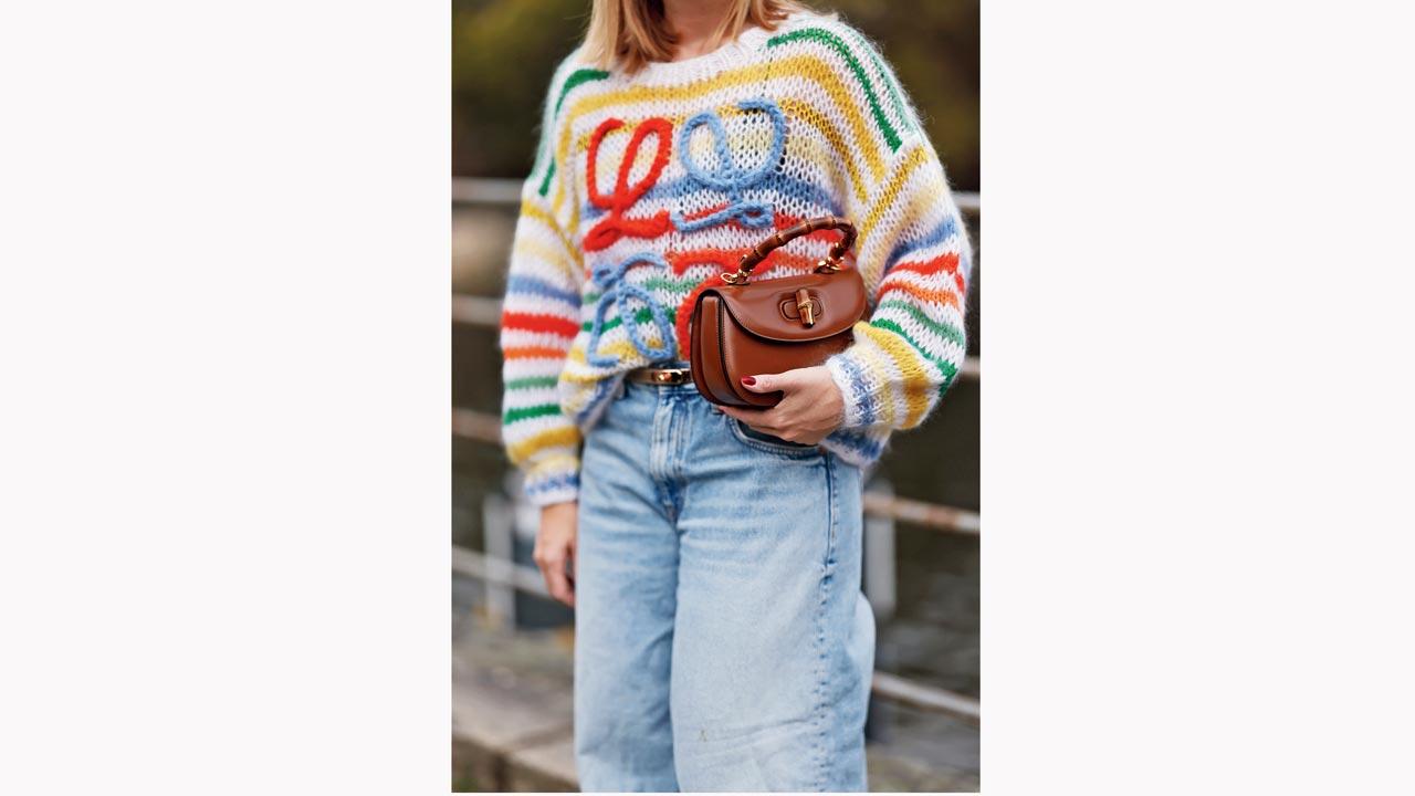 Sonia Lyson in a colourful striped wool knit sweater