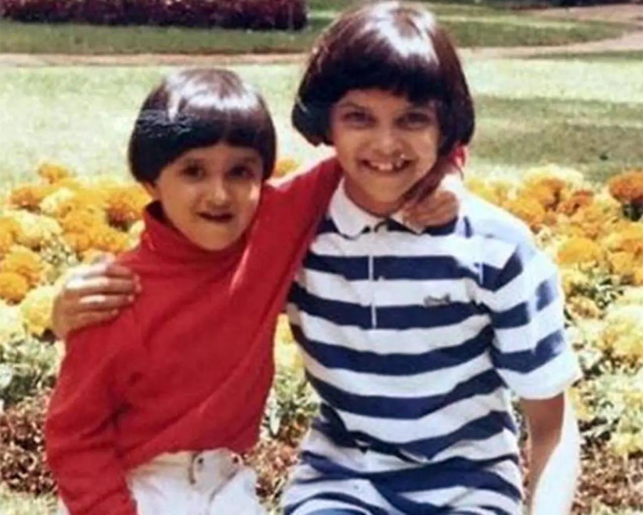 Deepika Padukone as a child. She looks adorable with a bowl cut set against a flower field.