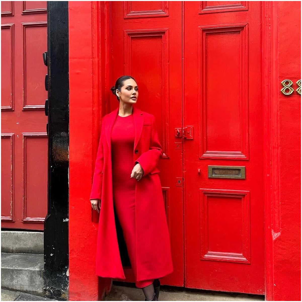 Posing against a red backdrop in a red outfit can be risky, but Esha shows us how it is done without blending in