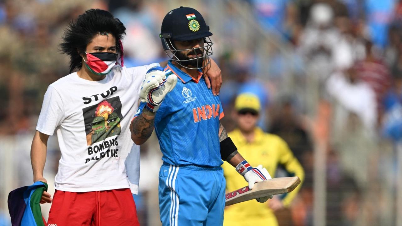 Pitch invader with Palestinian flag interrupts play, runs into Virat Kohli