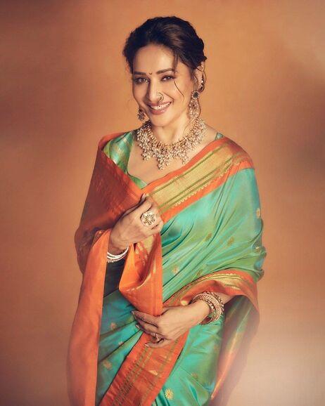 Dressed in a mint green and orange saree, Madhuri looked straight out of a dream. The Maharashtrian touch added by her was like a cherry on the cake 