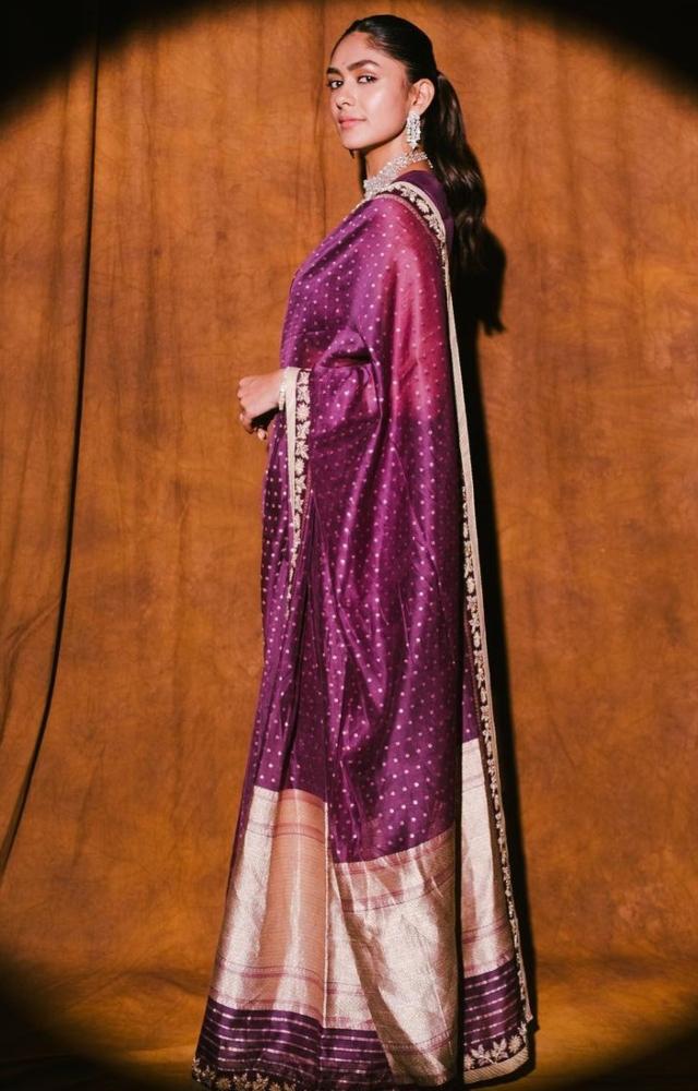 Mrunal Thakur wore a purple silk saree which looked festive and regal. Her hair was pulled back and the actress wore statement jewellery 