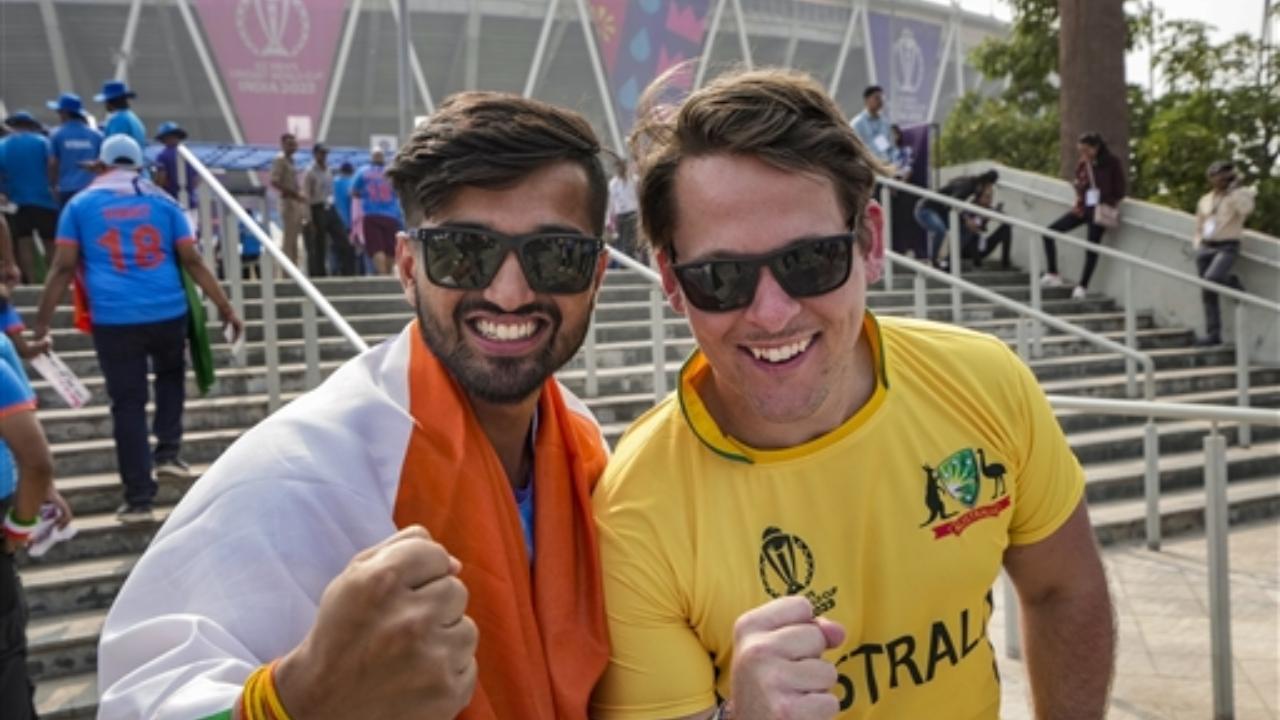 An Indian and an Australian fan pose for a photo outside the Narendra Modi Stadium before the ICC Men’s Cricket World Cup 2023 final