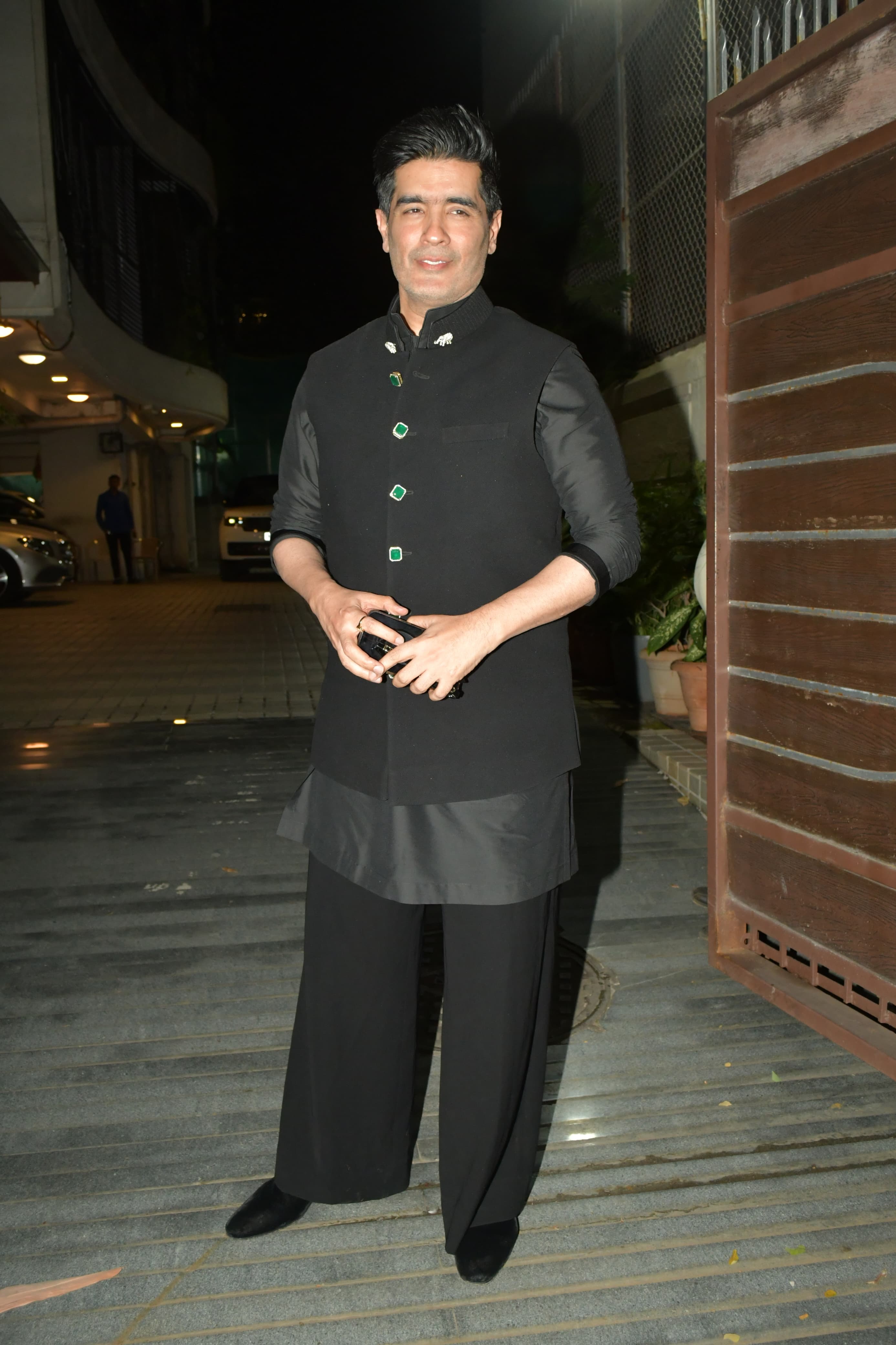 The designer chose a 2 piece black traditional suit with a modern touch for the party