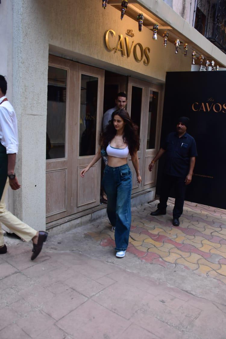 Disha Patani wore a simple white crop top and paired it with blue jeans as she visited a restaurant in the city