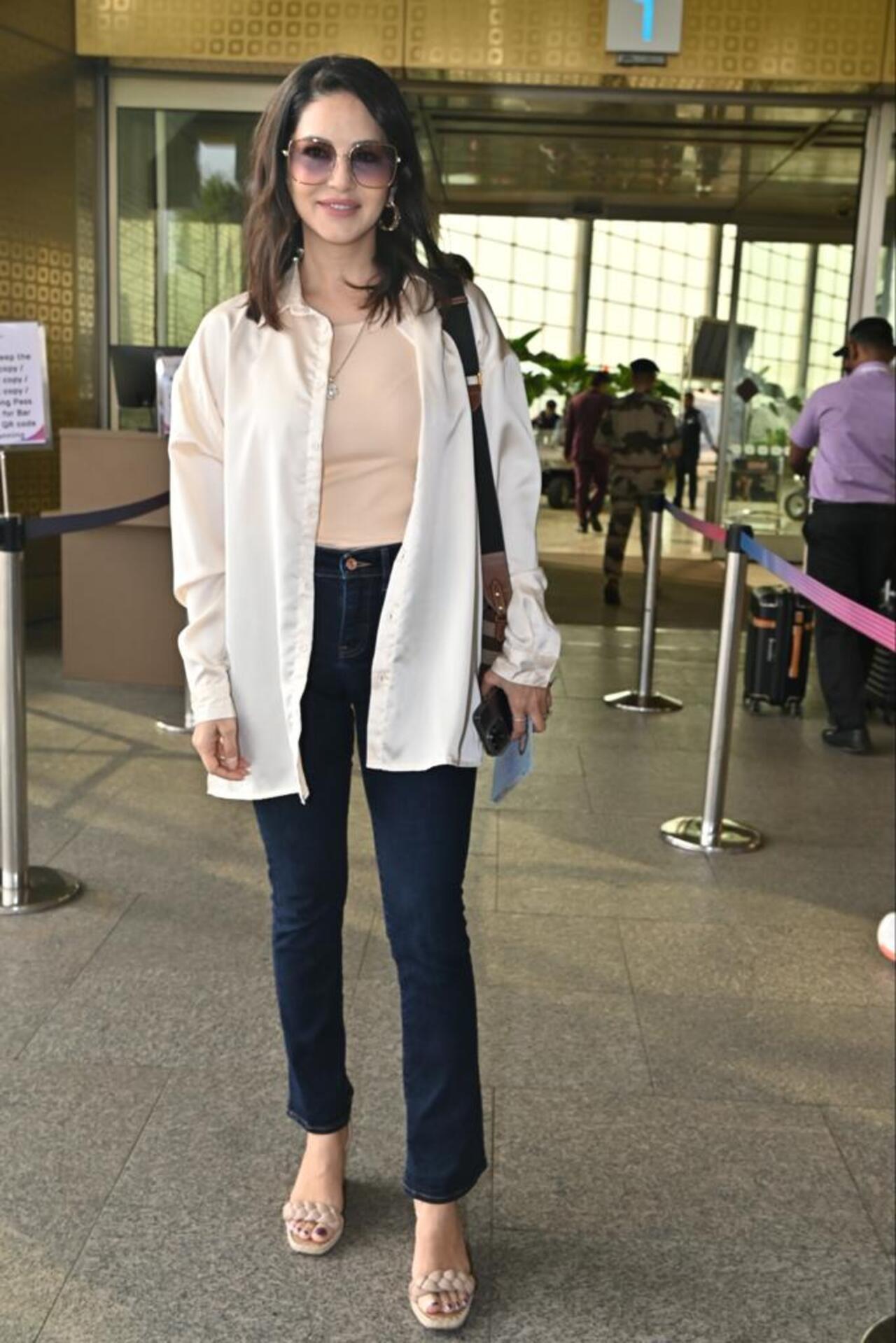 She was dressed in a pastel coloured top paired with a white jacket and black pants